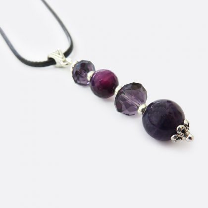 Collana fatta a mano, stile boho, in cordoncino nero, con pendente composto da una fila di mezzi cristalli dalle tonalità del viola.